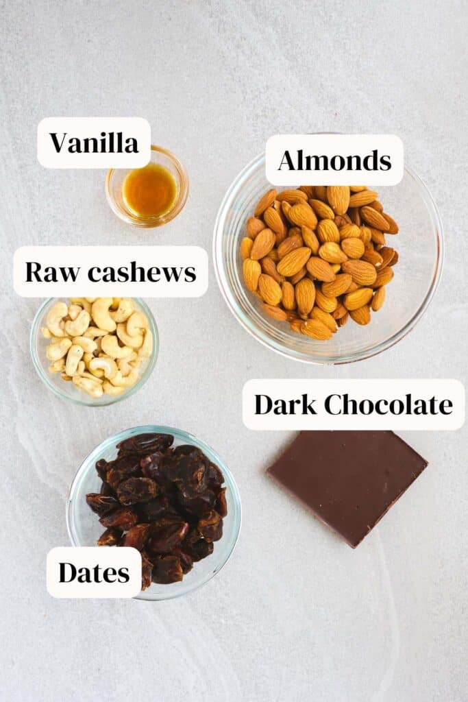 almonds, vanilla, raw cashews, dark chocolate, dates ingredients on platter