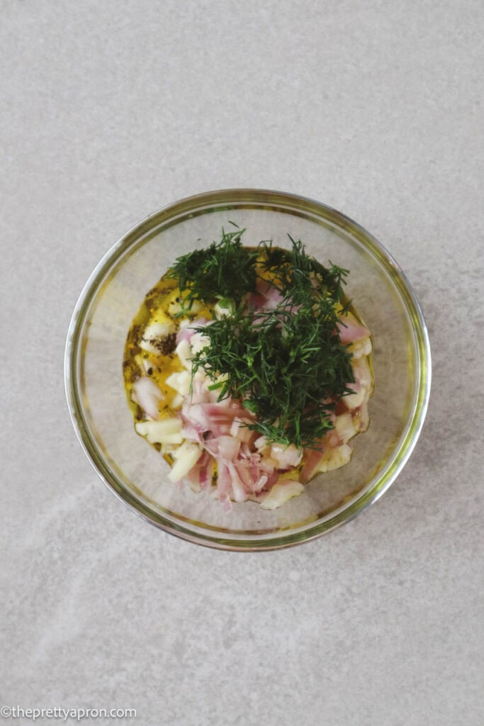 chopped shallots, garlic, dill, salt pepper and olive oil in small glass bowl