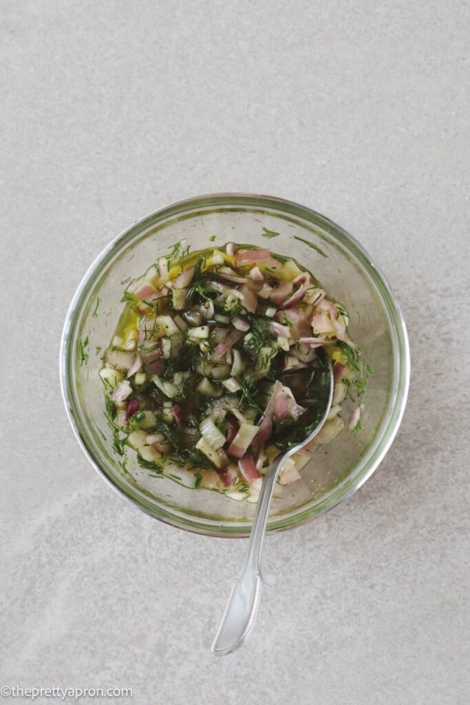 chopped dill, shallots, garlic, salt, pepper, olive oil mixed in small glass bowl