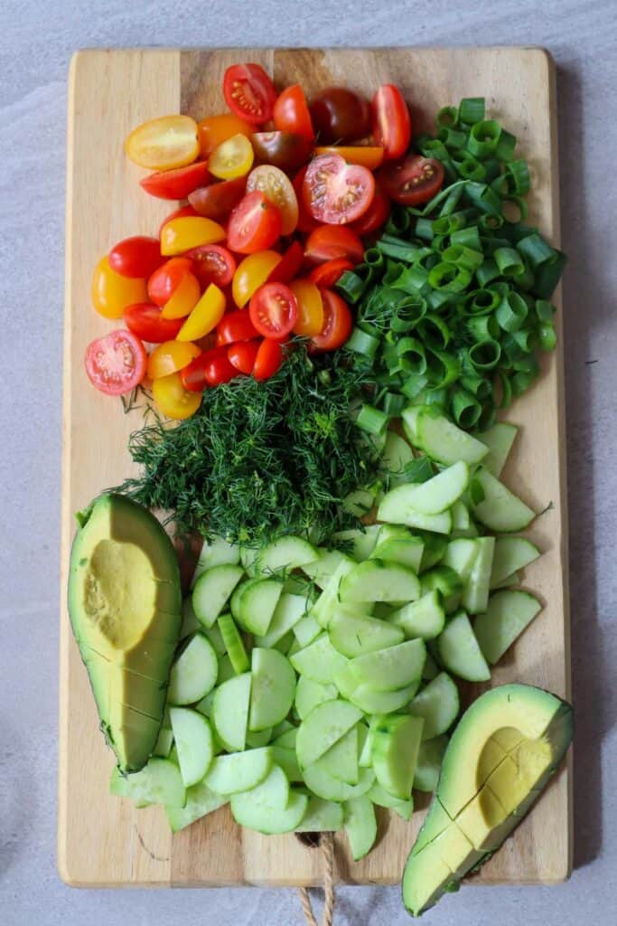 chopped cucumber, baby tomatoes, avocado, dill and parsley