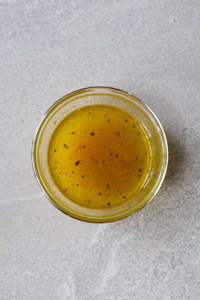 salmon and quinoa salad dressing in small bowl