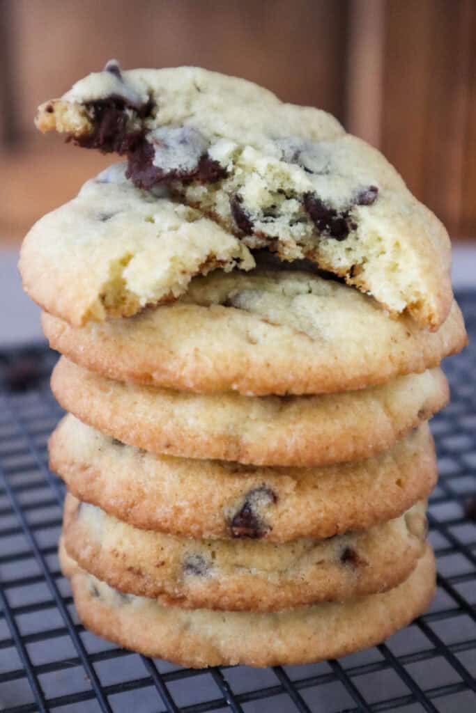 Close up of stack of chocolate chip cookies made without brown sugar and bite taken of one cookie