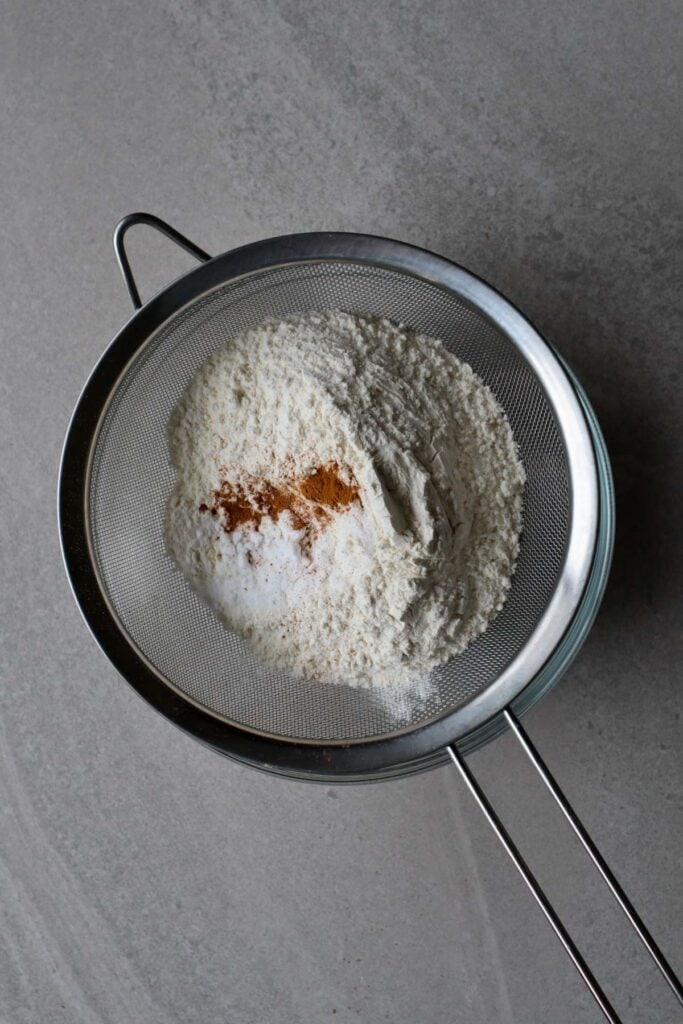sifting flour, baking soda, salt and cinnamon