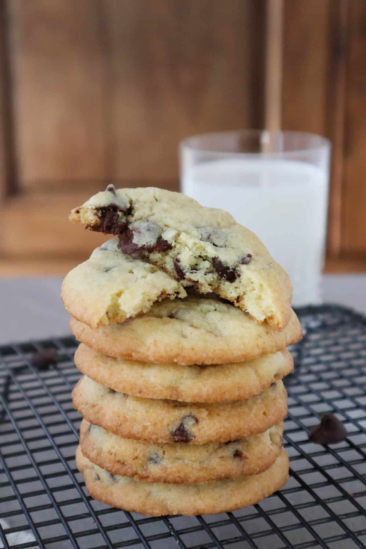 Stack of chocolate chip cookies made without brown sugar with glass of milk