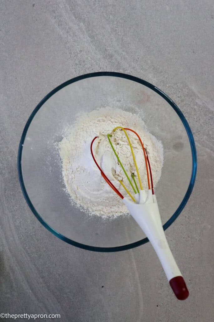 whisked together flour, baking soda, baking powder in glass bowl