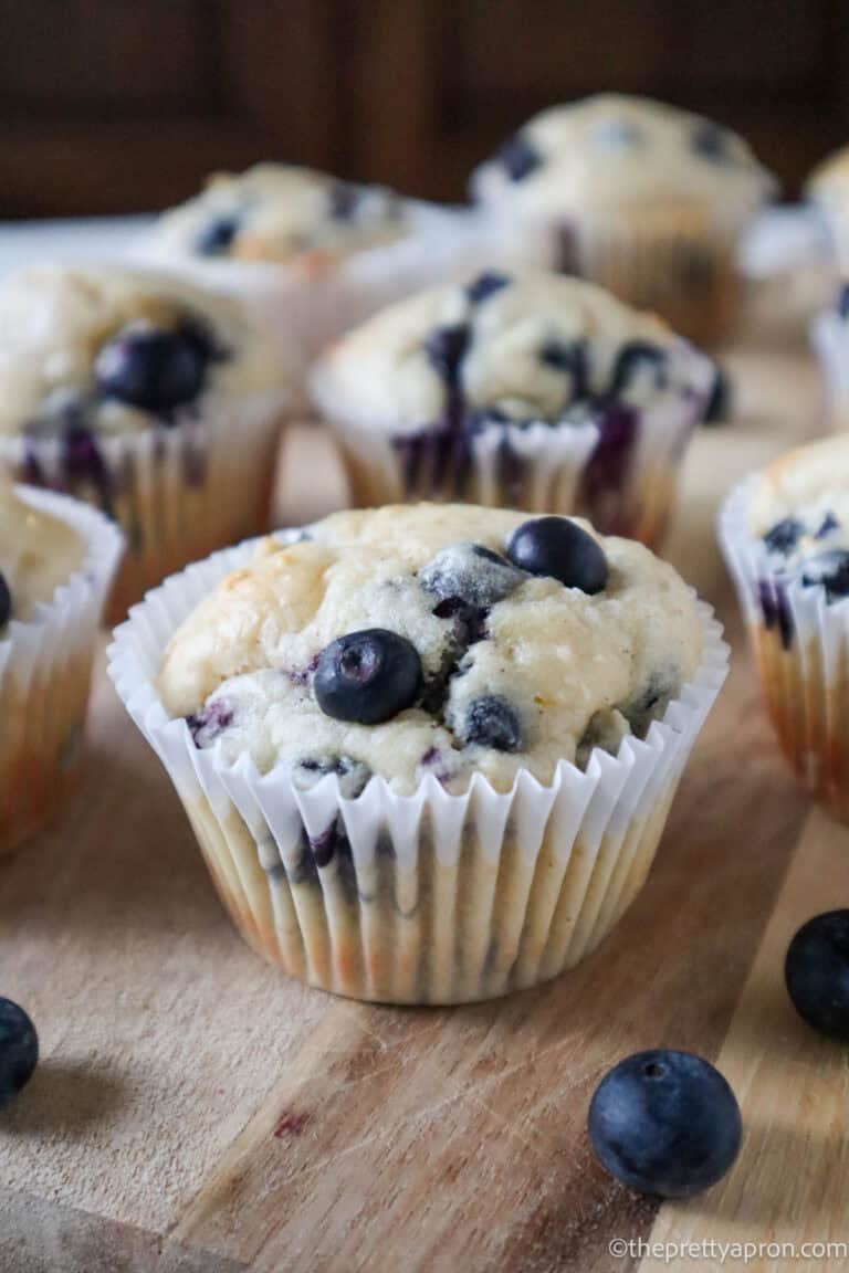 Four Blueberry cottage cheese muffins on a cooling rack