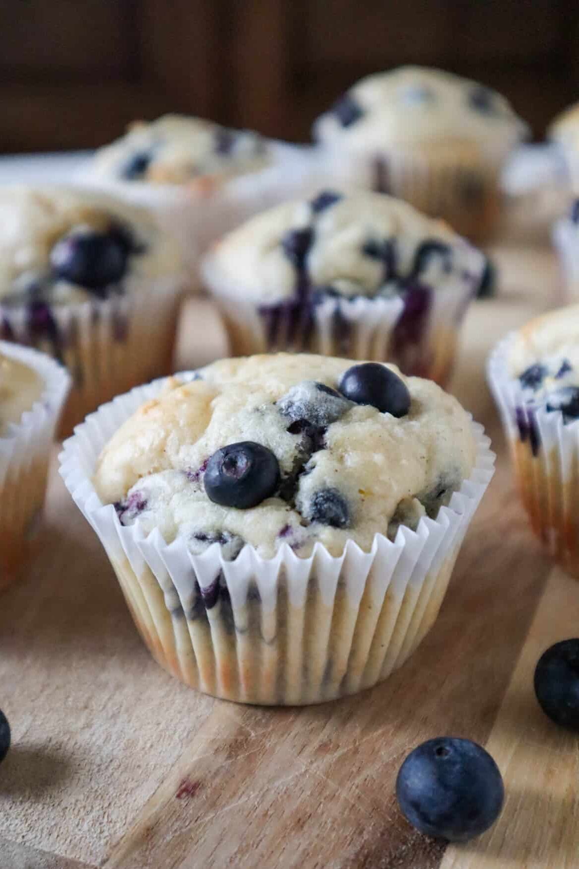 Four Blueberry cottage cheese muffins on a cooling rack