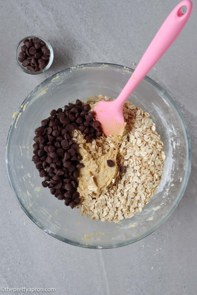 chocolate chips and old fashioned oats added to cookie dough