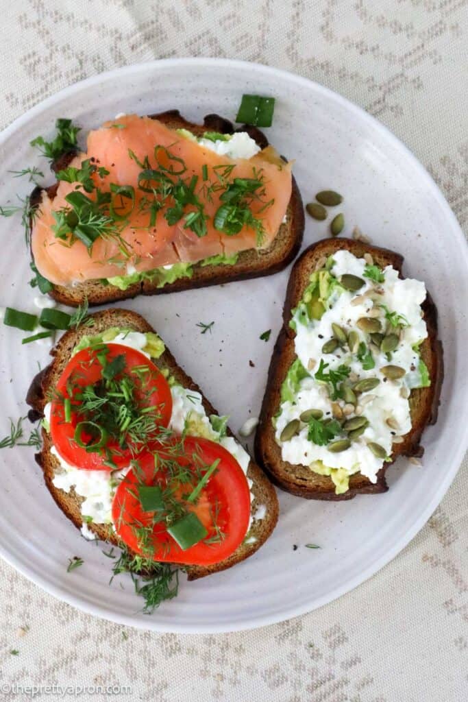 Trio of cottage cheese avocado toast with tomato, smoked salmon and seeds