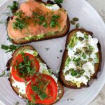 Trio of cottage cheese avocado toast with tomato, smoked salmon and seeds