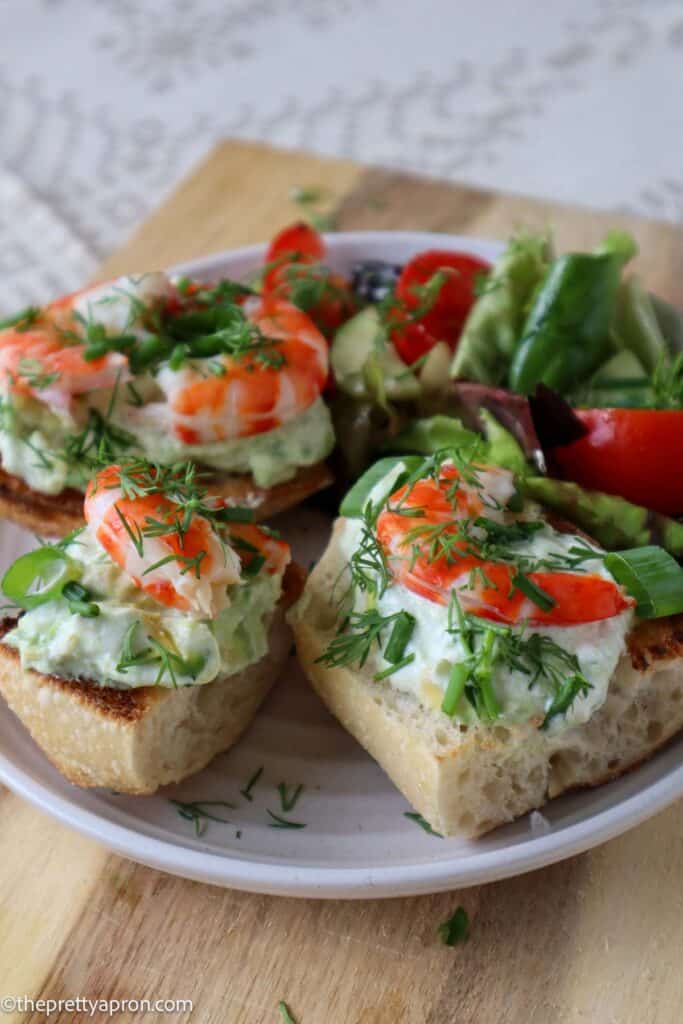shrimp and avocado toast on plate with garden salad