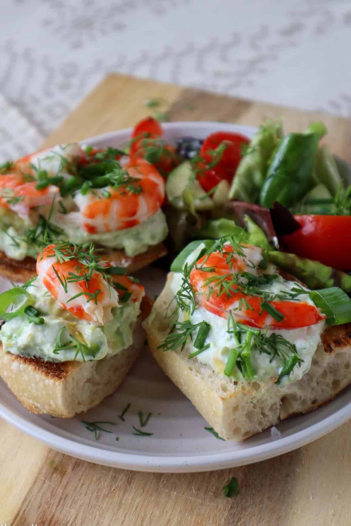 shrimp and avocado toast on plate with garden salad
