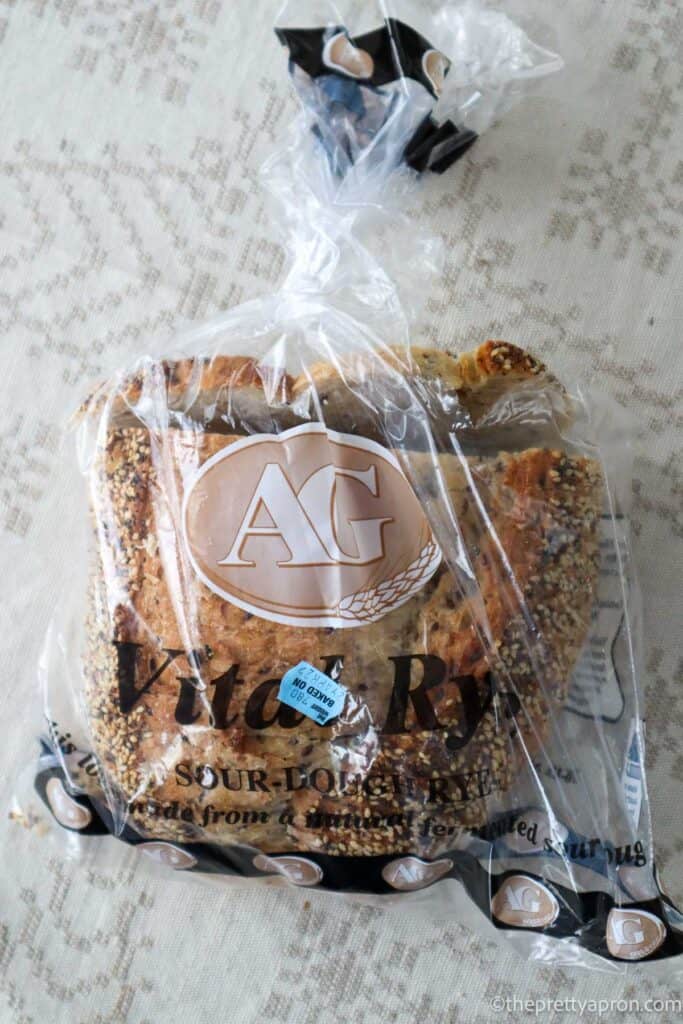 Sourdough bread in a plastic bag, placed on a linen tablecloth