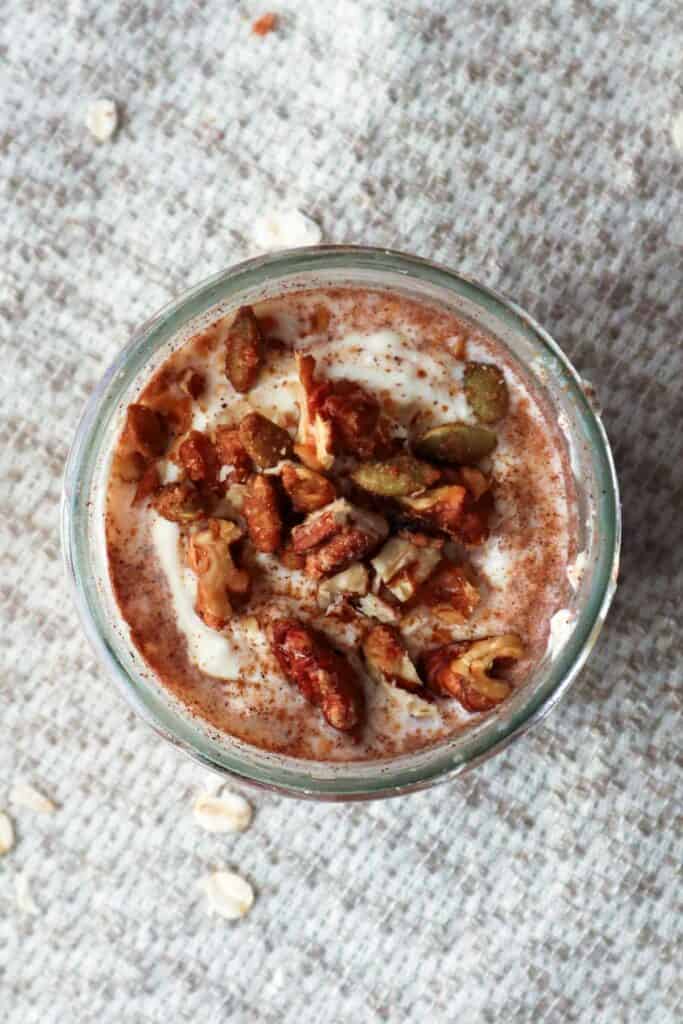 cinnamon roll overnight oats topped with chopped nuts.