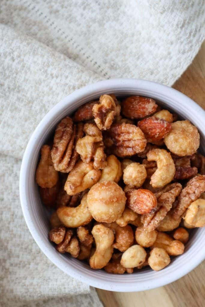 Maple roasted nuts in beige bowl with linen napkin.