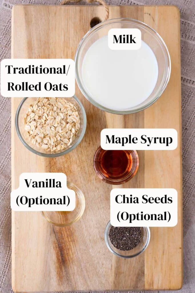 Oats, maple syrup, milk, vanilla, chia seeds, each in a little glass bowl on a wooden board.