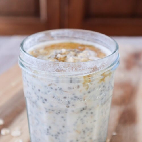 maple overnight oats with chia seeds and yogurt on wooden board.