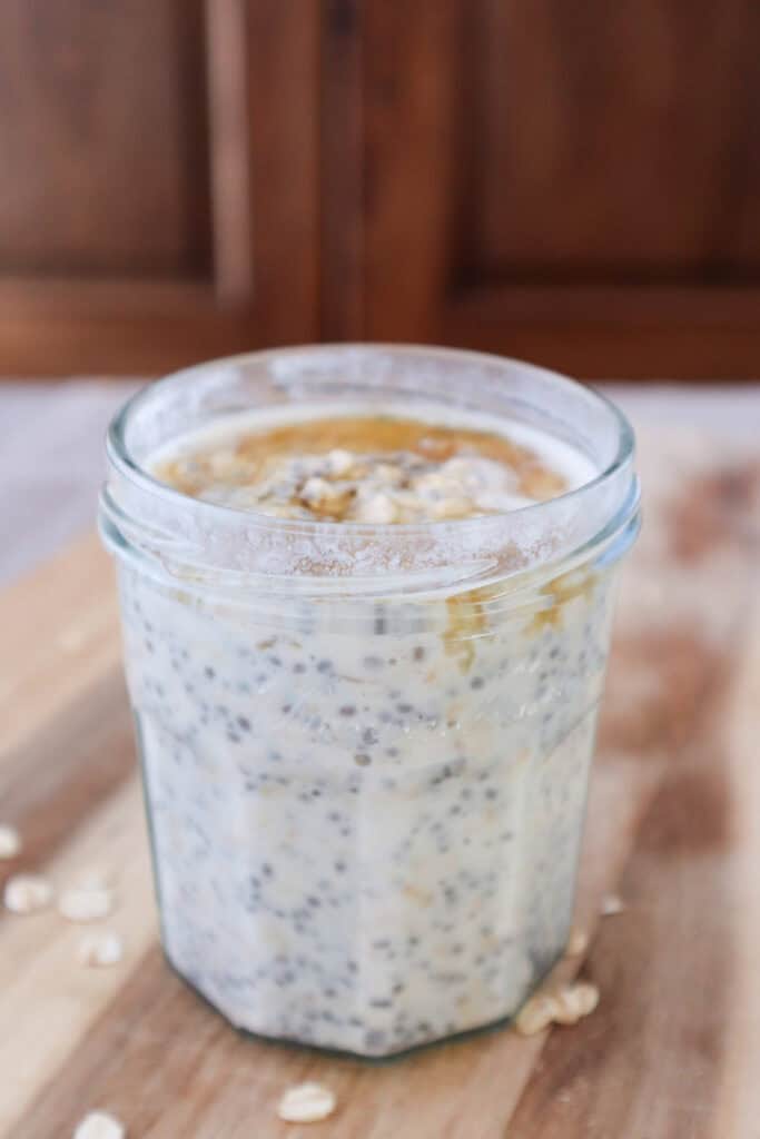 maple overnight oats with chia seeds and yogurt on wooden board.
