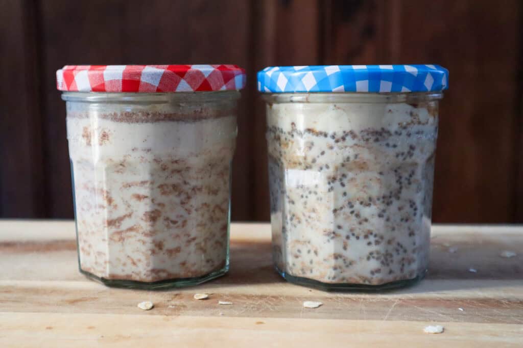 Two jars of cinnamon roll overnight oats. On the left no chia seeds, on the right with chia seeds.