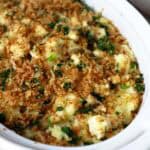 Cottage cheese mashed potatoes topped with crispy panko crumbs topping in beige dish.