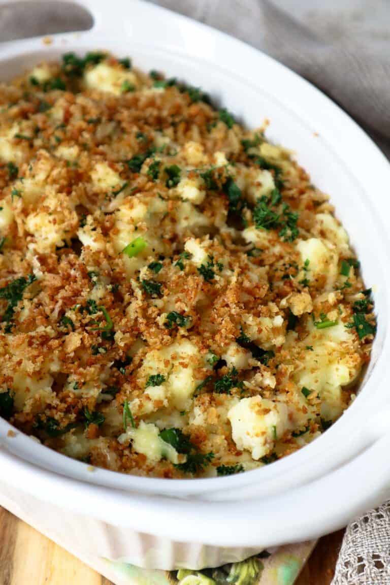 Cottage cheese mashed potatoes topped with crispy panko crumbs topping in beige dish.