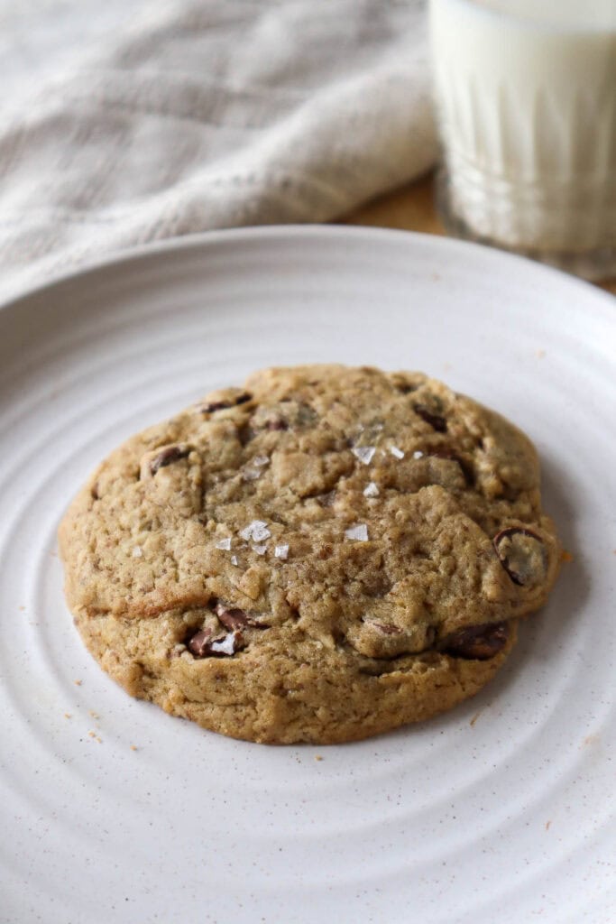 Oatmeal chocolate chip cookie made with aquafaba on a beige plate.