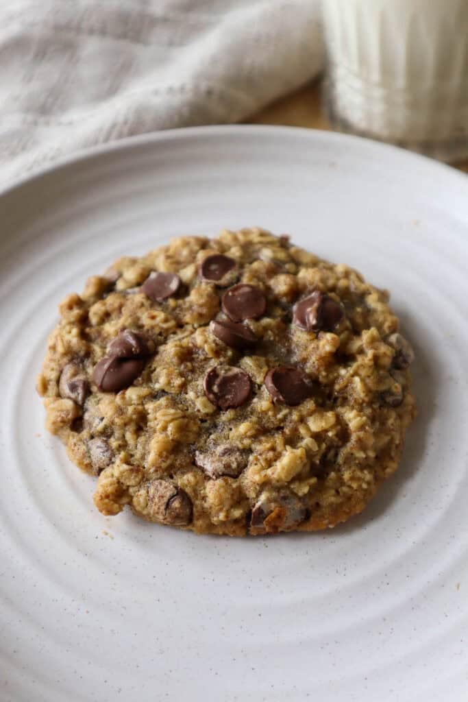 Oatmeal chocolate chip cookie made with ground flaxseed on a beige plate.