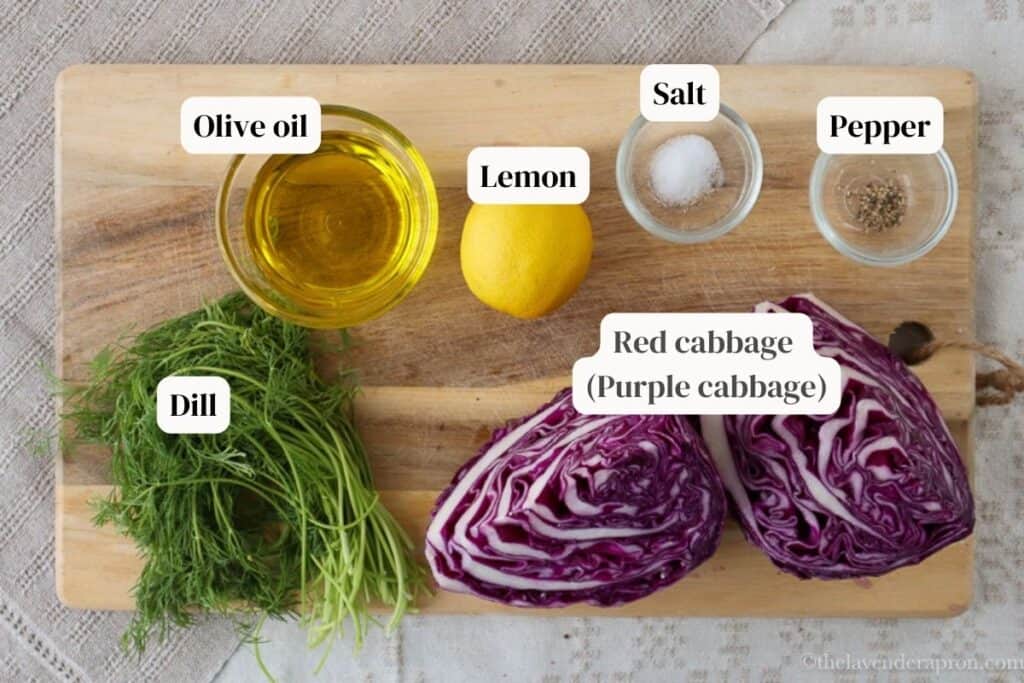 Ingredients for purple cabbage coleslaw including cabbage, dill, lemon and olive oil
