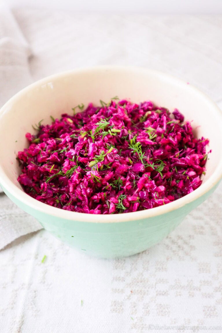 Red cabbage salad recipe with dill in a light green bowl.