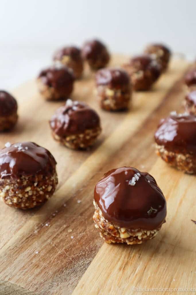 Chocolate almond balls on a wooden board.