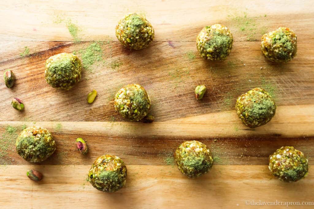 No bake Matcha energy balls on a wooden board.