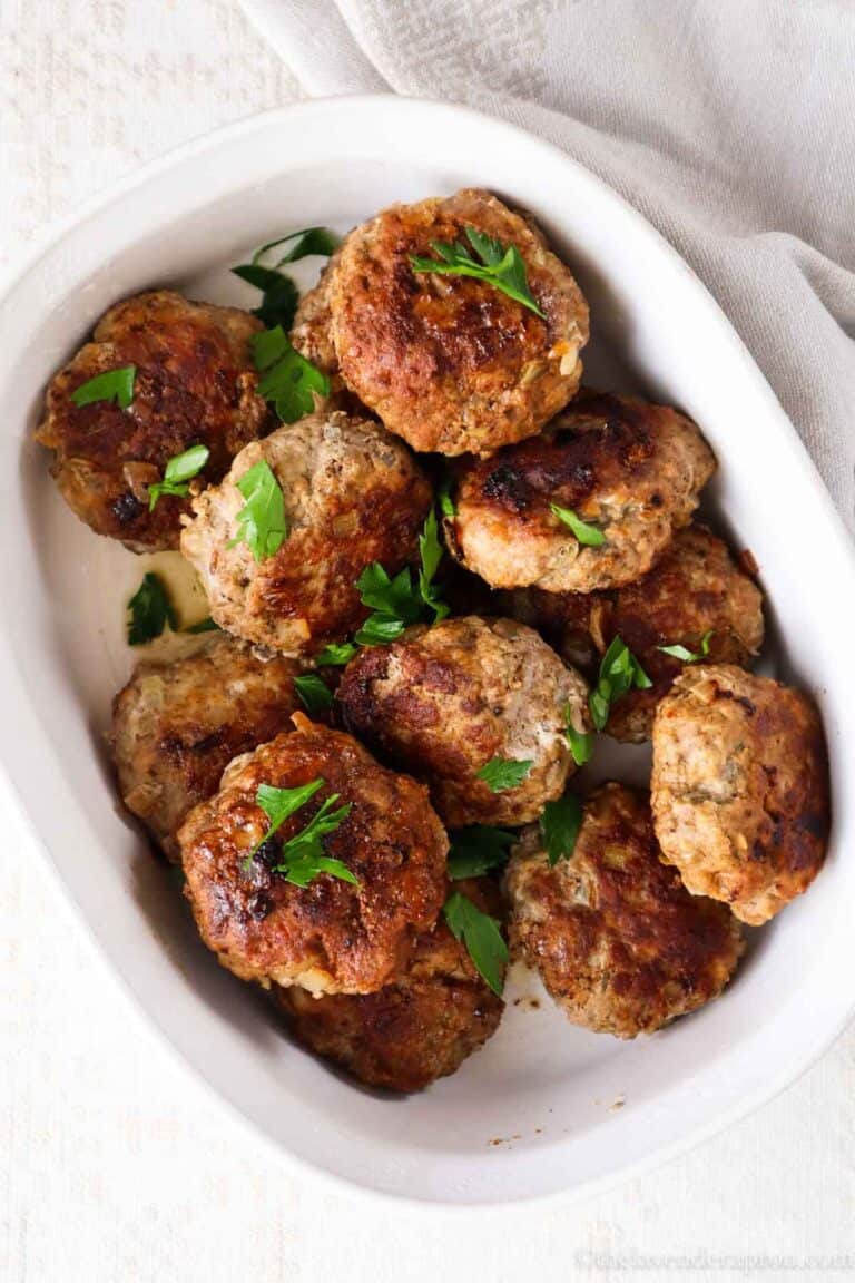 Latvian kotletes in a white serving dish.