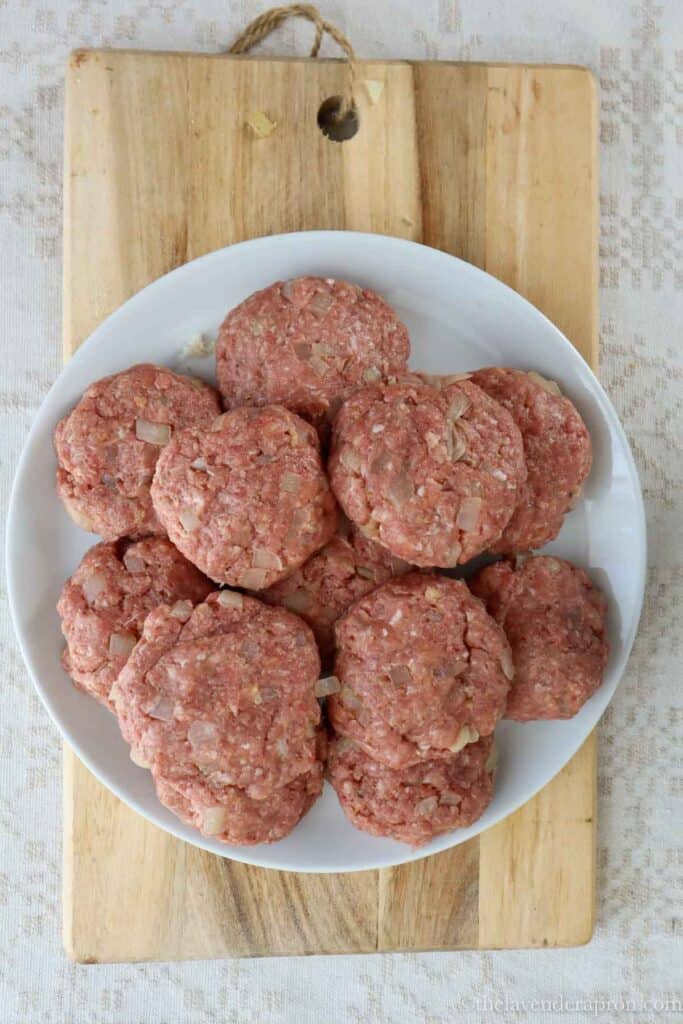 Shaped Latvian meat patties on a plate.