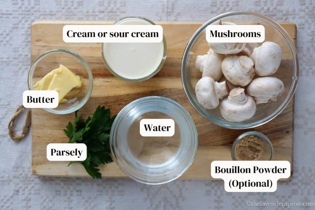 Mushroom cream sauce ingredients on a wooden board.