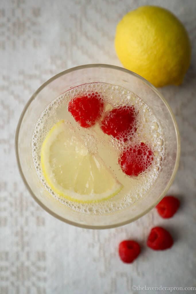Serving chamomile honey lemonade with some raspberries.
