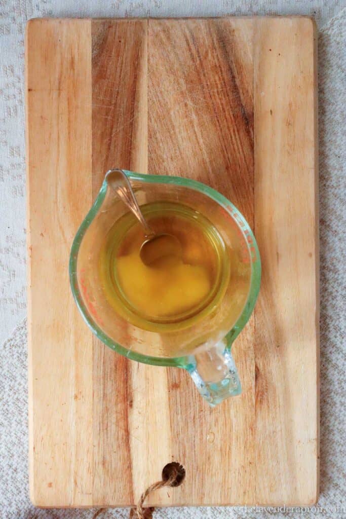 Stirring the honey into the warm, but not hot, chamomile tea.