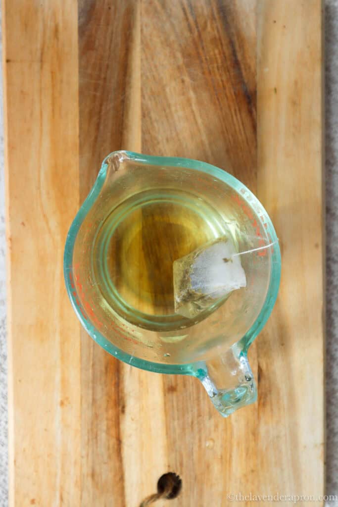 Seeping chamomile tea bag in a cup of hot water.