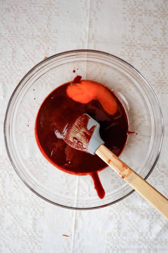 Adding egg yolk and cooled coffee to chocolate mixture.