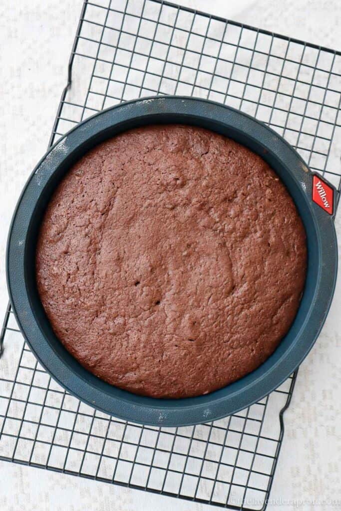 Belgian chocolate cake cooling on a wire rack.