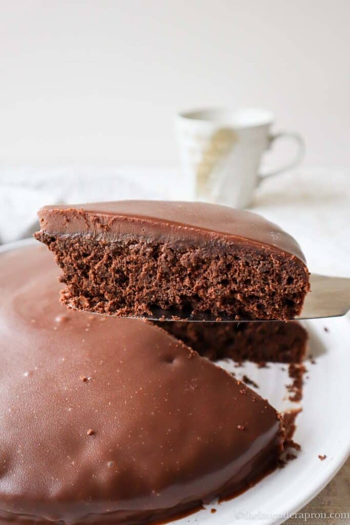 Belgian chocolate cake slice with Belgian chocolate ganache taken out of the whole cake.