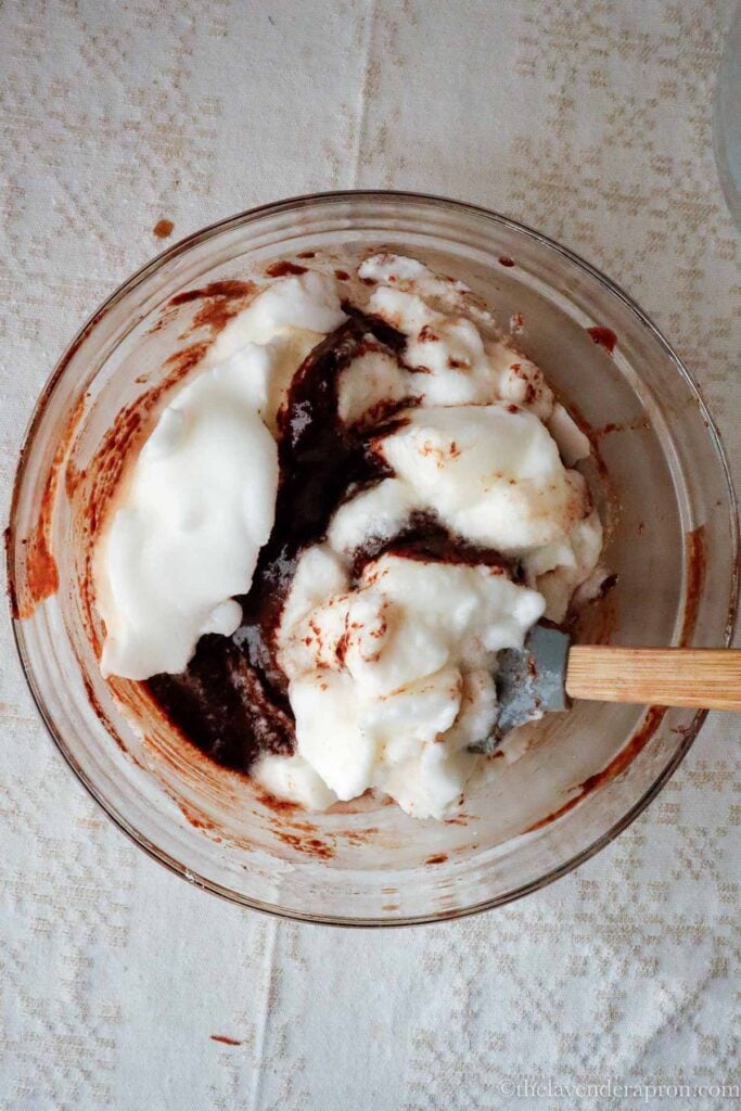 Folding in whipped egg whites into Belgian chocolate mixture.