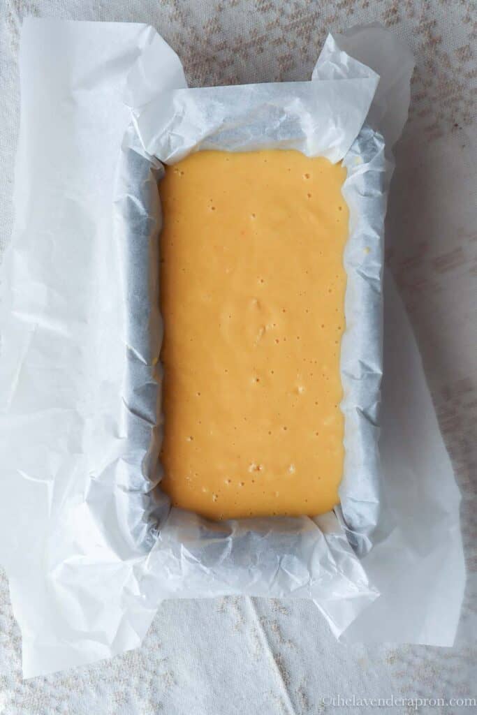 French yogurt cake batter poured into prepared loaf tin.