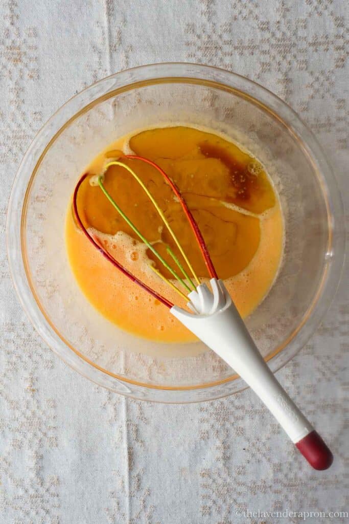 Adding olive oil and vanilla to the French yogurt batter.