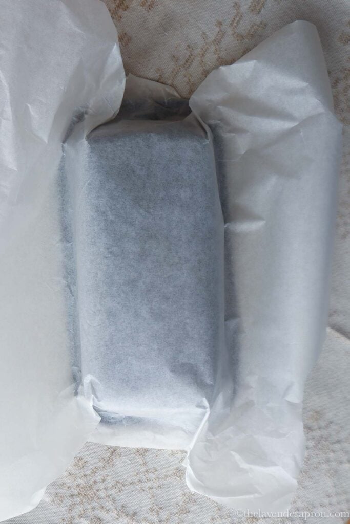 Wrapping the outside of a loaf pan with baking paper to get clean edges.