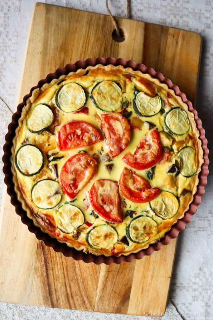 Quiche provencale made with zucchini, tomatoes, red peppers, yellow peppers, eggplant and onions.