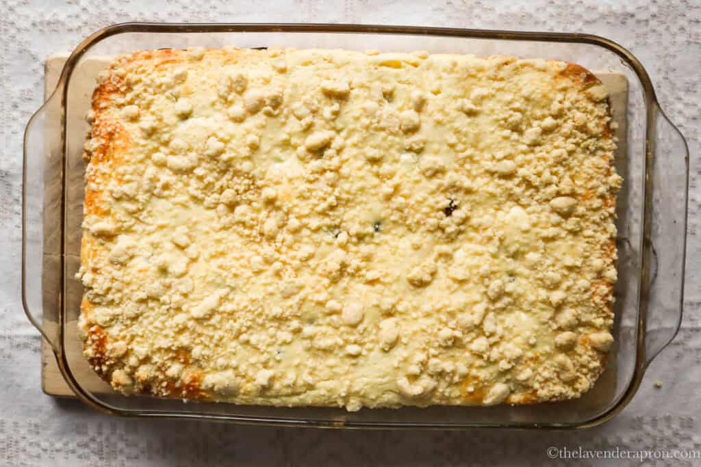 golden crumb topping on baked Latvian cottage cheese cake in a Pyrex dish.
