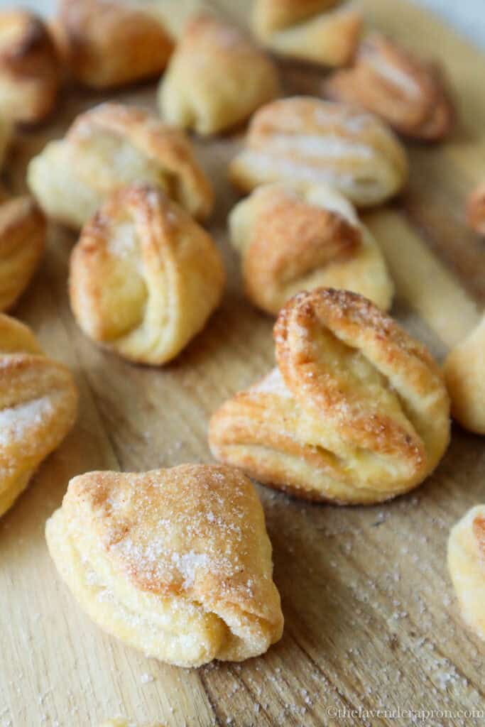 A close-up of crisp Latvian cottage cheese cookies, sugar coating visible