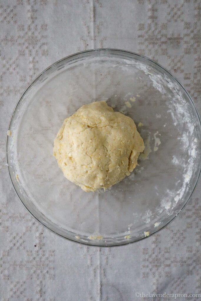 Chilled biezpiena cepumi dough resting in a glass bowl.