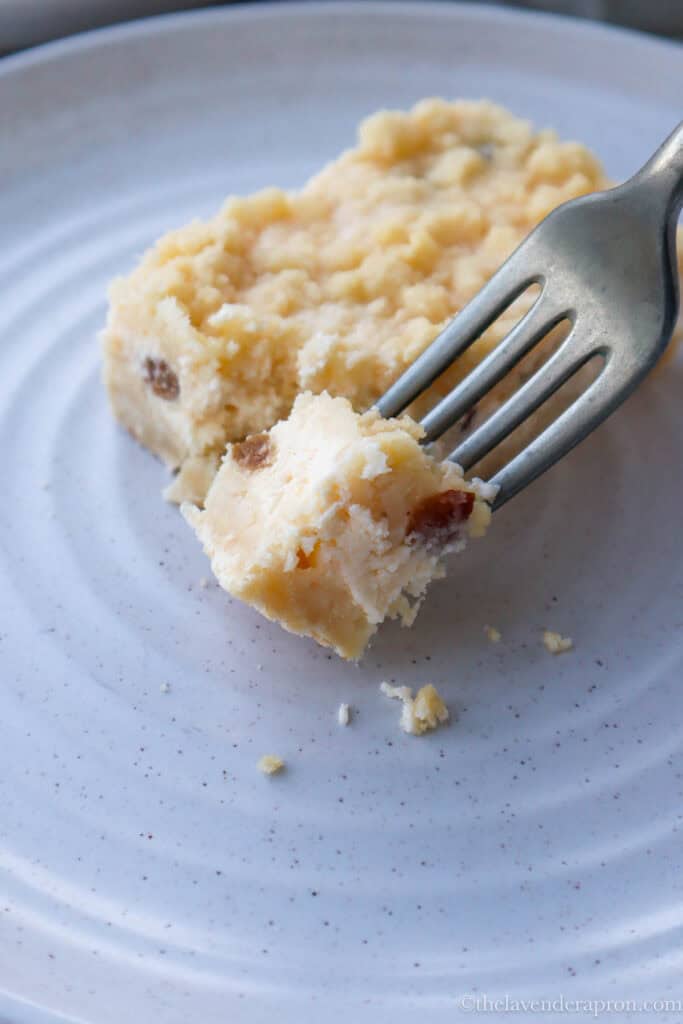 Forkful of cottage cheese cake (Latvian biezpienmaize) up close with streusel topping.