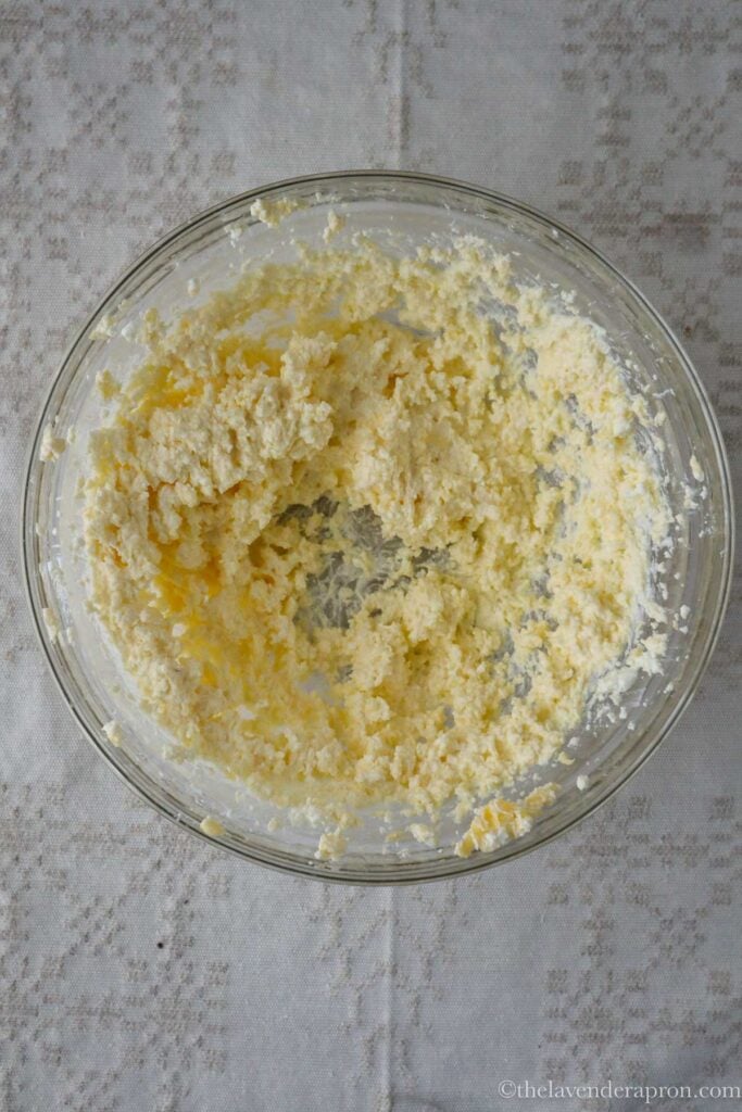 Mixing the cottage cheese and butter together in a bowl.